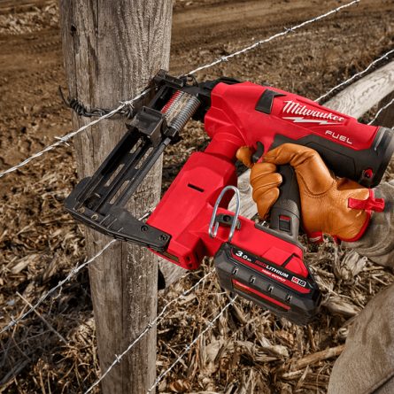 Battery Powered Cordless Staple Gun Being used on Fence