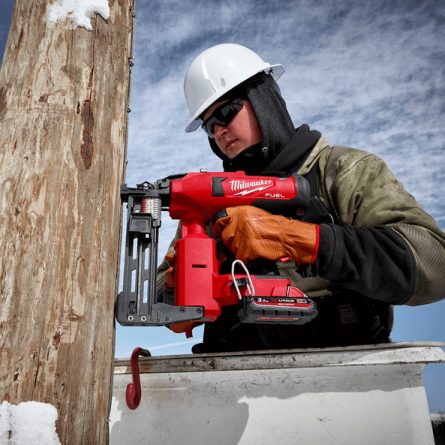 Battery Powered Cordless Staple Gun Being used on Pole
